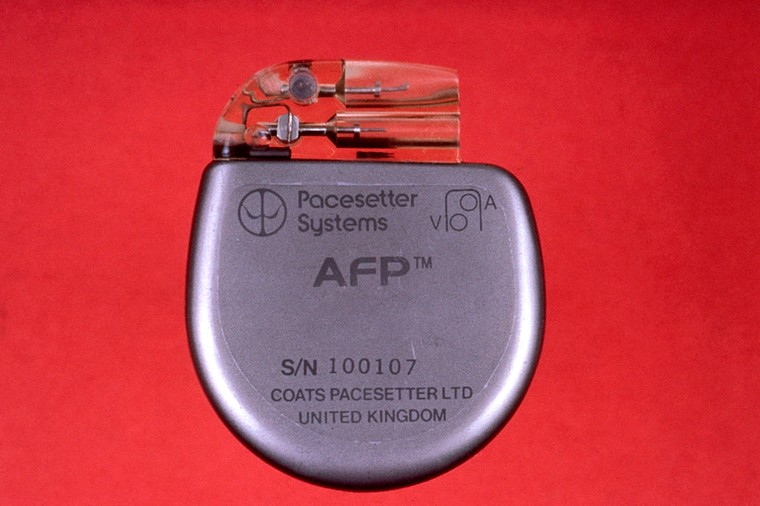 A rounded silver object with clear plastic section at the top. On the silver part it reads, "Pacesetter Systems, AFP. S/N 100107, Coats Pacesetter Ltd, United Kingdom."