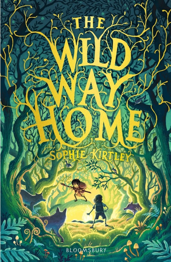 Book Cover: The Wild Way Home by Sophie Kirtley, published by Bloomsbury. Cover illustration shows two boys standing in a wild-looking forest clearing. The boy facing the viewer looks to be wearing animal skins and holds a spear. He is hunched defensively. Facing him, with his back to the viewer, is a boy in modern-day shorts and T-shirt. He has no weapon but also stands defensively. Watching the standoff from the trees are three wolves.